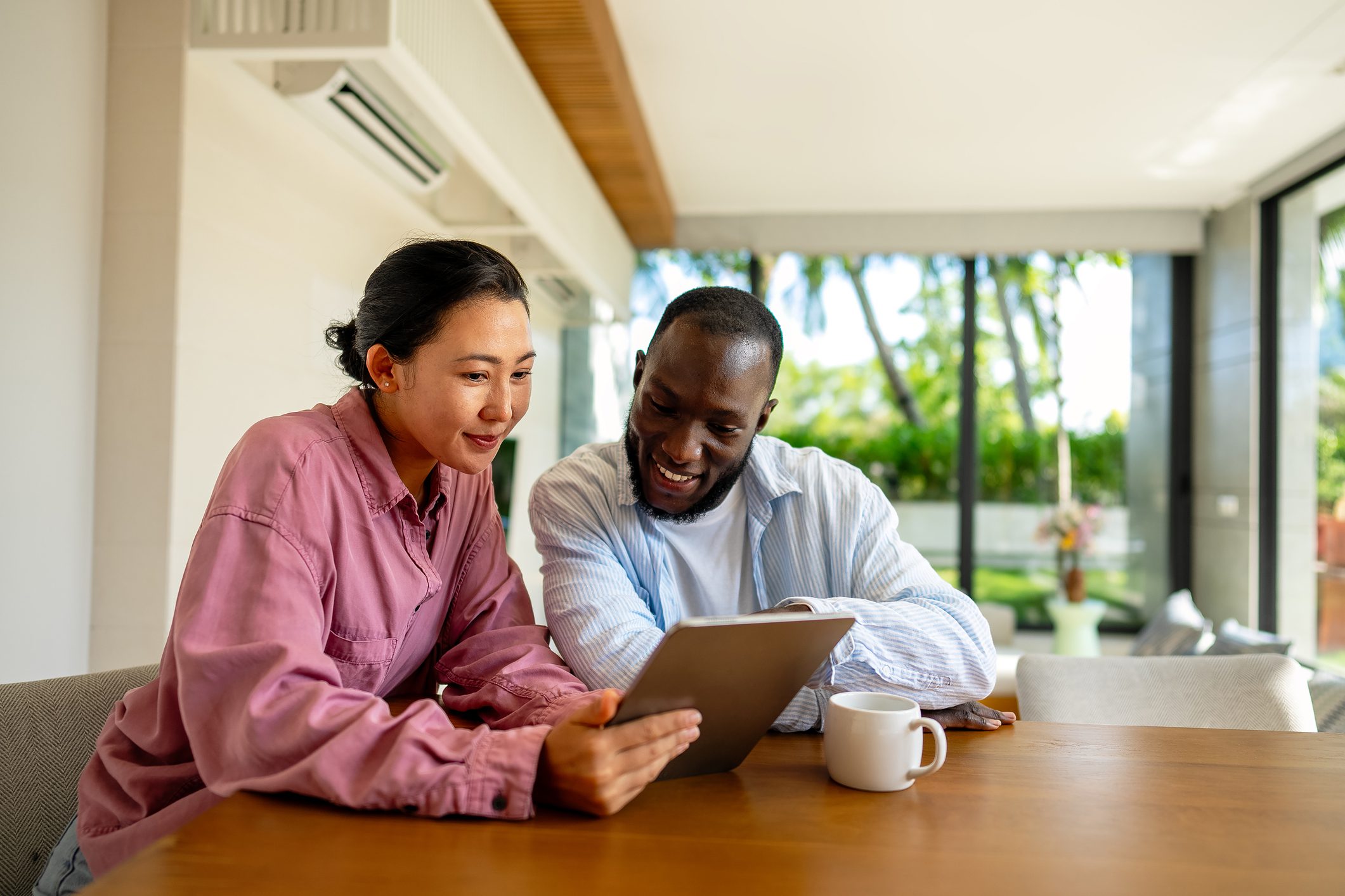 Happy pair browsing content together at table