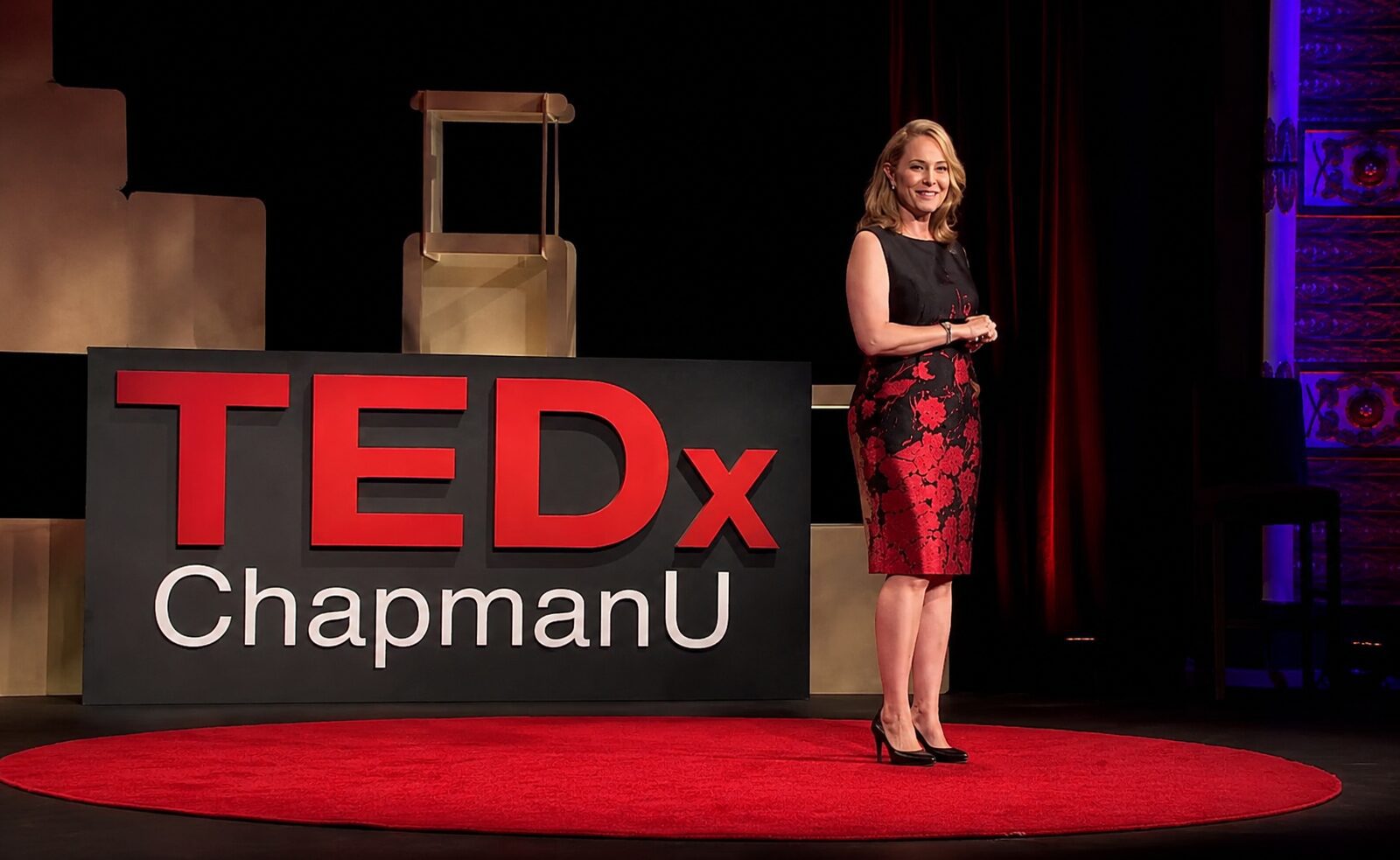 Speaker on stage at TEDx ChapmanU event.