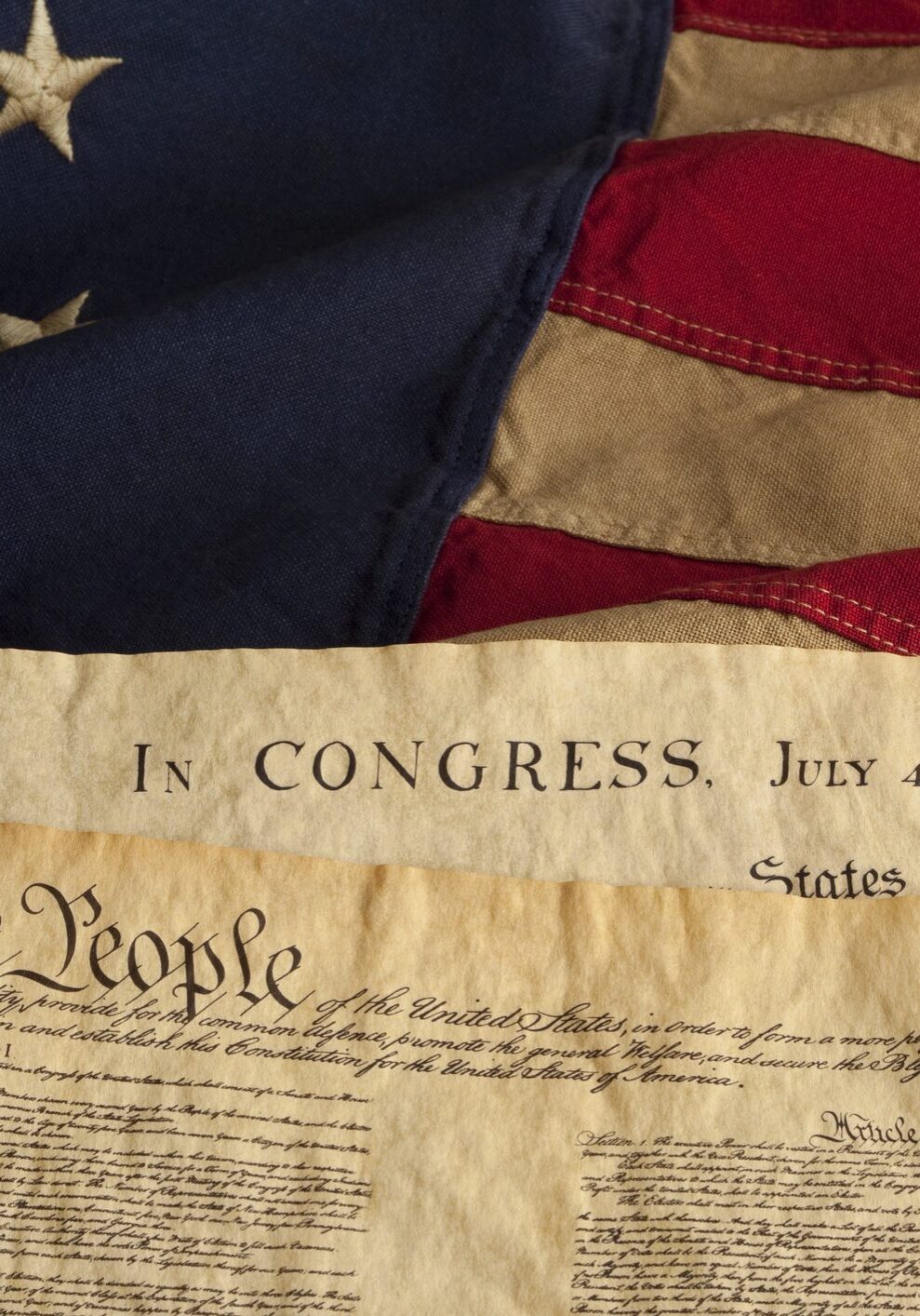 U.S. flag with Declaration and Constitution documents.